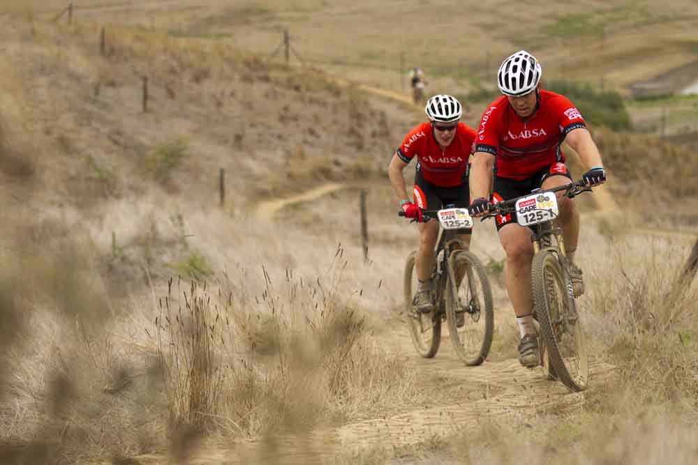 MEERENDAL 23 MARCH 2014 - John Smit & Christopher Chorley of Barney's Army during the Prologue of the 2014 Absa Cape Epic Mountain Bike stage race held at Meerendal Wine Estate in Durbanville outside Cape Town, South Africa on the 23 March 2014. Photo: Gary Perkin/Cape Epic/SPORTZPICS