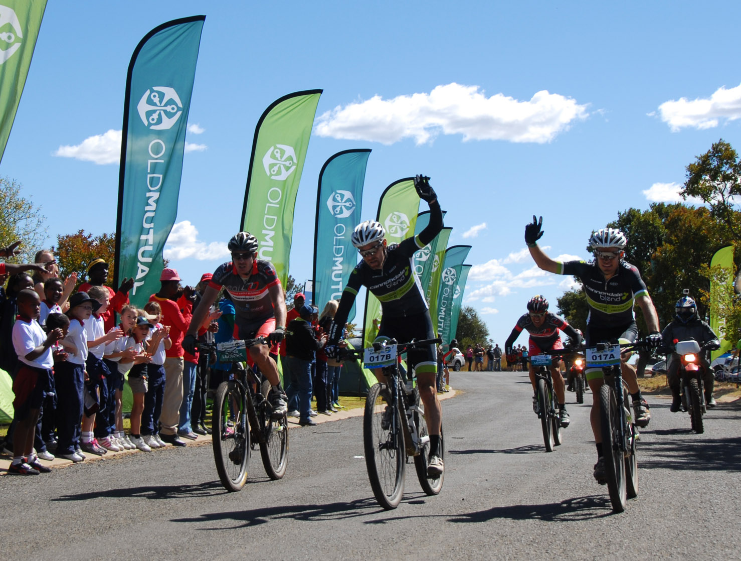 CAPTION: Cannondale-Blend’s Waylon Woolcock (centre) and Darren Lill (right) savour the victory on day three of the nine-day Old Mutual joBerg2c at Sterkfontein Dam in the Free State on Sunday. Photo: Alistair Schorn